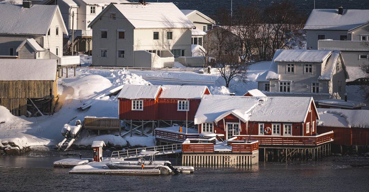 Idyllic snow covered scandinavian village by the sea in winter